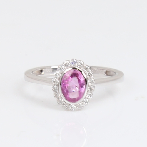 1182 - A modern 14ct white gold pink sapphire and diamond cluster ring, set with oval mixed-cut sapphire an... 