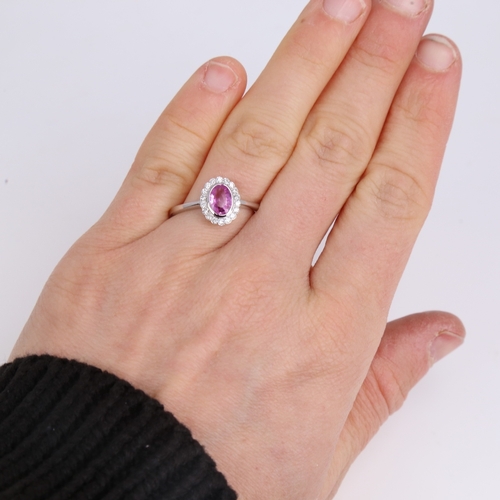 1182 - A modern 14ct white gold pink sapphire and diamond cluster ring, set with oval mixed-cut sapphire an... 