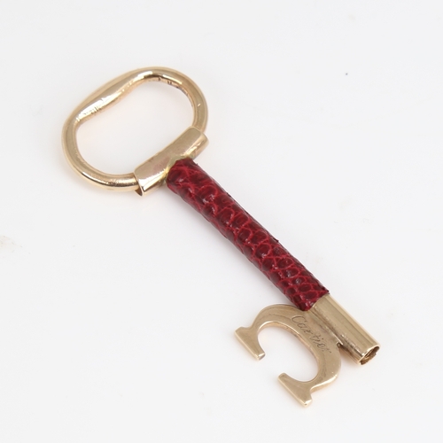 1192 - CARTIER - a Vintage 9ct gold and red leather key pendant, signed and numbered 76961, hallmarks Londo... 