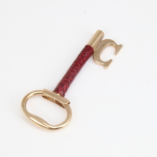 1192 - CARTIER - a Vintage 9ct gold and red leather key pendant, signed and numbered 76961, hallmarks Londo... 