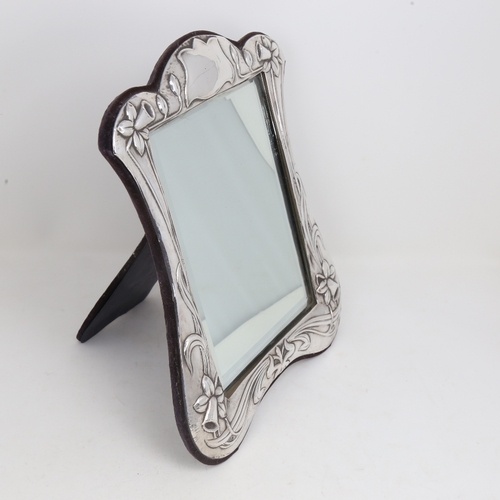 1198 - An Elizabeth II Art Nouveau style silver-fronted dressing table strut mirror, relief embossed daffod... 