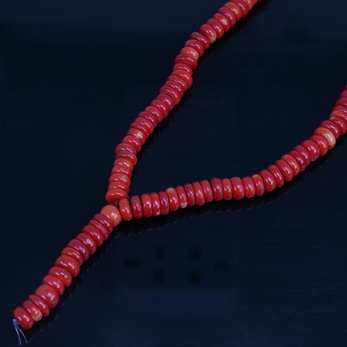 1203 - A string of red coral beads, necklace length 34cm, 65.3g