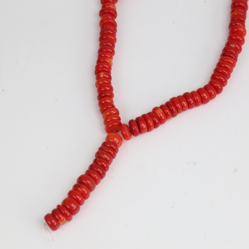 1203 - A string of red coral beads, necklace length 34cm, 65.3g