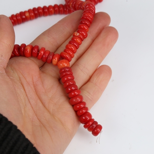 1203 - A string of red coral beads, necklace length 34cm, 65.3g