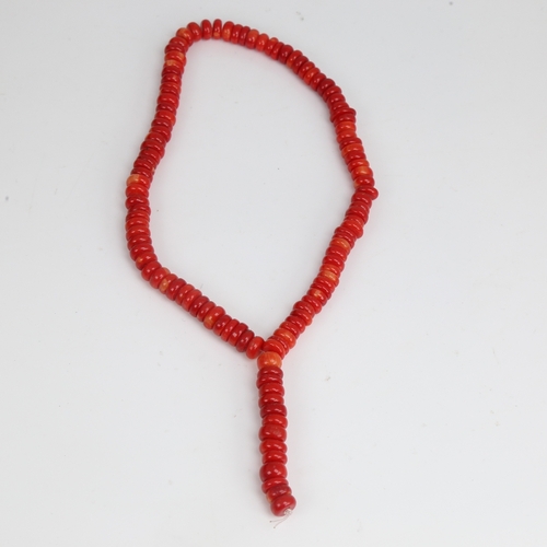 1203 - A string of red coral beads, necklace length 34cm, 65.3g