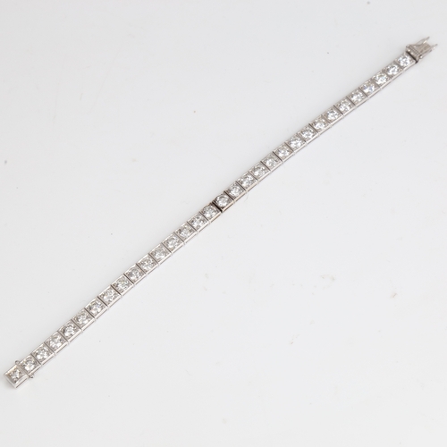 1205 - A fine Vintage 18ct white gold diamond line bracelet, set with 32 modern round brilliant-cut diamond... 