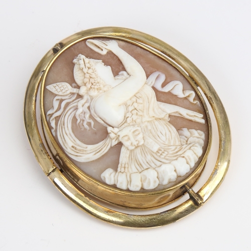 1207 - A Victorian relief carved shell cameo swivel brooch, depicting Bacchante lady with lion pelt and thy... 