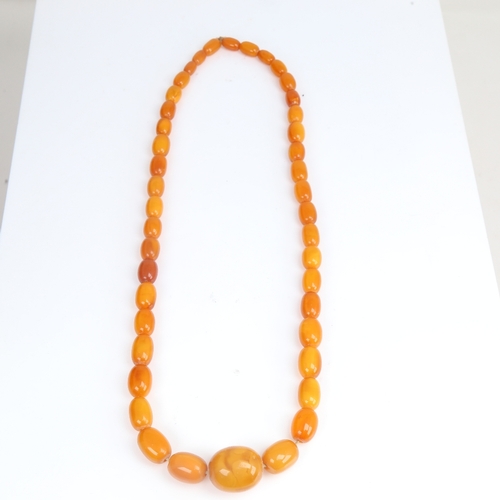 1213 - A long graduate single-row butterscotch amber bead necklace, beads measuring from 27.8mm to 13.4mm, ... 