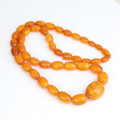 1213 - A long graduate single-row butterscotch amber bead necklace, beads measuring from 27.8mm to 13.4mm, ... 