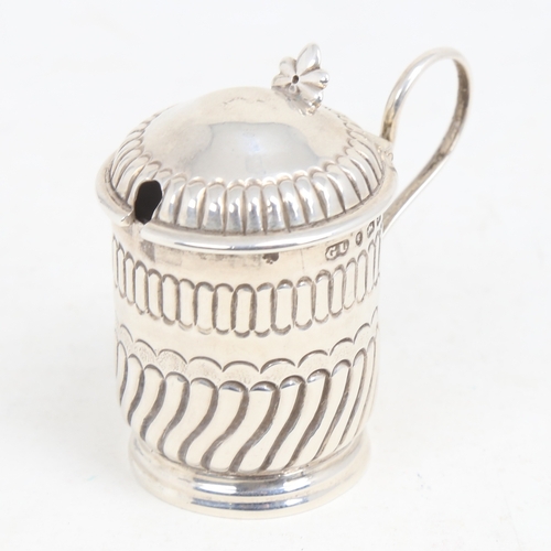 1216 - A Victorian silver mustard pot, formed as a tankard, half fluted form with blue glass liner, by Geor... 