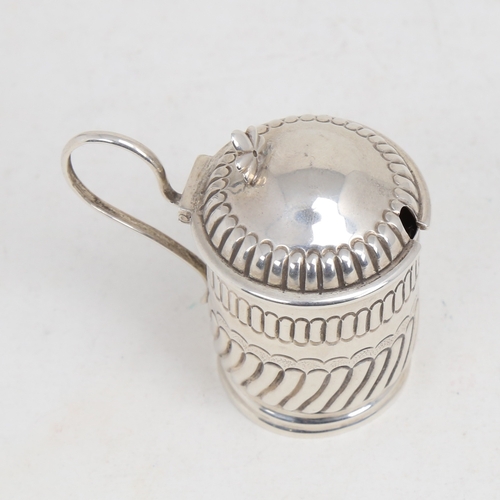 1216 - A Victorian silver mustard pot, formed as a tankard, half fluted form with blue glass liner, by Geor... 