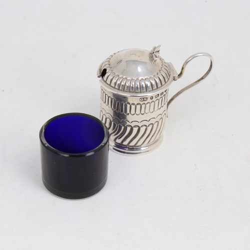 1216 - A Victorian silver mustard pot, formed as a tankard, half fluted form with blue glass liner, by Geor... 