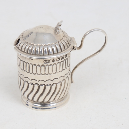 1216 - A Victorian silver mustard pot, formed as a tankard, half fluted form with blue glass liner, by Geor... 