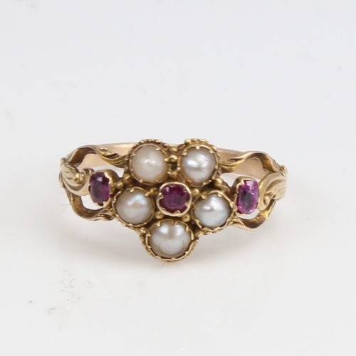 1227 - A Victorian unmarked gold split-pearl and ruby cluster memorial ring, central flowerhead design with... 