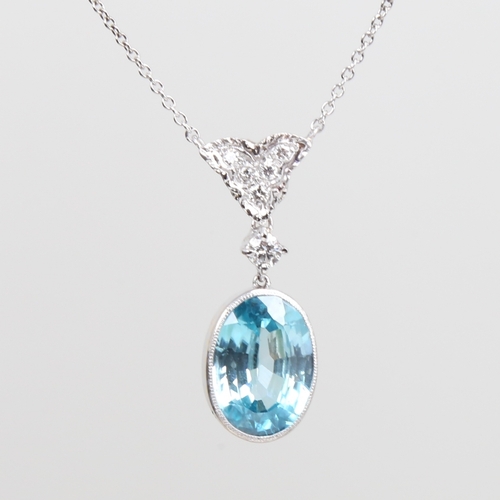 1242 - A platinum zircon and diamond pendant necklace, set with 9ct oval mixed-cut zircon drop and round br... 