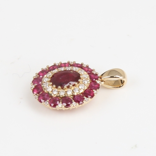 1243 - A modern 14ct gold ruby and diamond cluster pendant, set with oval mixed and round-cut rubies with r... 