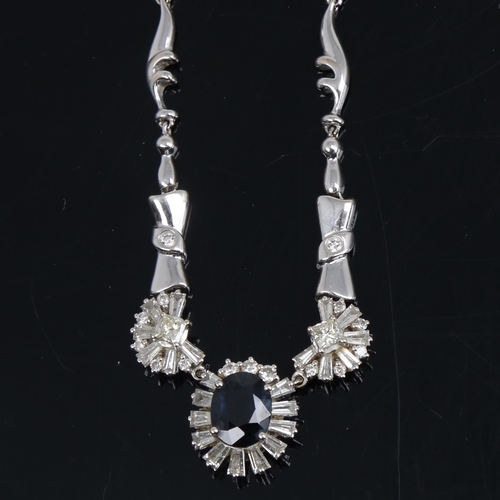 1253 - A modern 18ct white gold sapphire and diamond cluster necklace, set with 2.85ct oval-cut sapphire, s... 