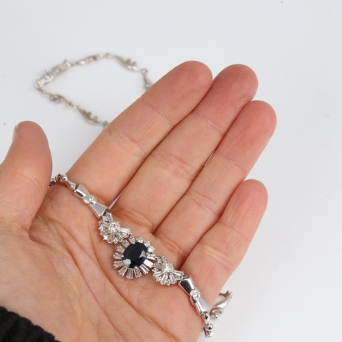 1253 - A modern 18ct white gold sapphire and diamond cluster necklace, set with 2.85ct oval-cut sapphire, s... 