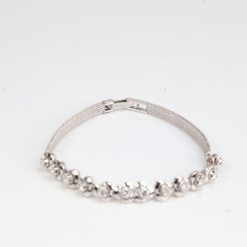 1256 - A late 20th century 18ct white gold diamond trefoil bracelet, set with round brilliant-cut diamonds,... 