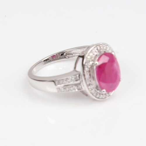 1262 - A modern 14ct white gold pink sapphire and diamond cluster ring, set with oval mixed-cut sapphire an... 