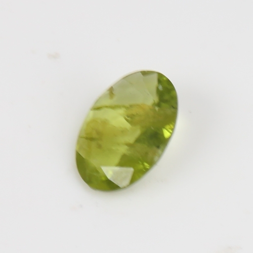 1290 - A 5.07ct unmounted oval mixed-cut peridot, dimensions: 14.70mm x 10.88mm x 4.05mm, 1.01g, with IDT C... 