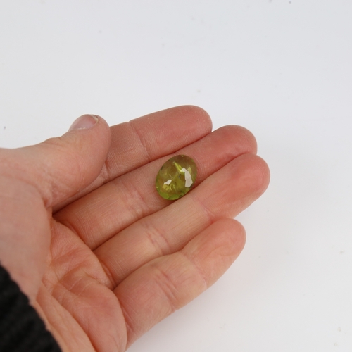 1290 - A 5.07ct unmounted oval mixed-cut peridot, dimensions: 14.70mm x 10.88mm x 4.05mm, 1.01g, with IDT C... 