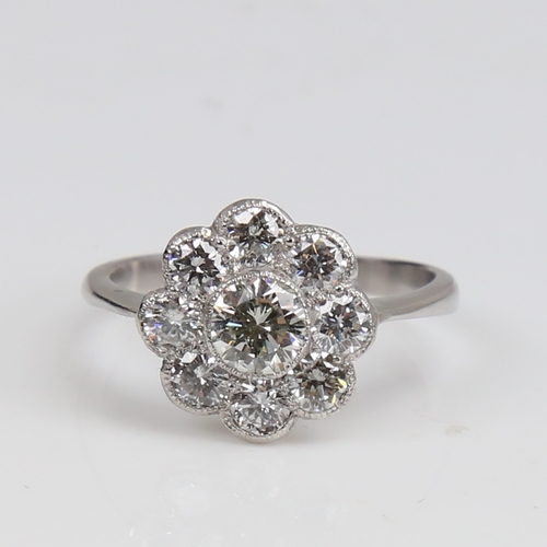 1292 - An unmarked white gold diamond cluster flowerhead ring, set with modern round brilliant-cut diamonds... 