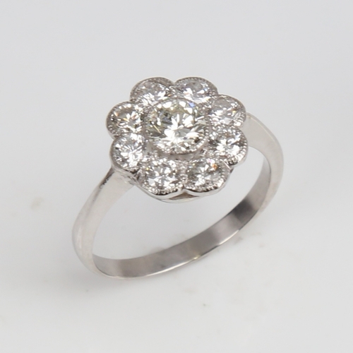 1292 - An unmarked white gold diamond cluster flowerhead ring, set with modern round brilliant-cut diamonds... 