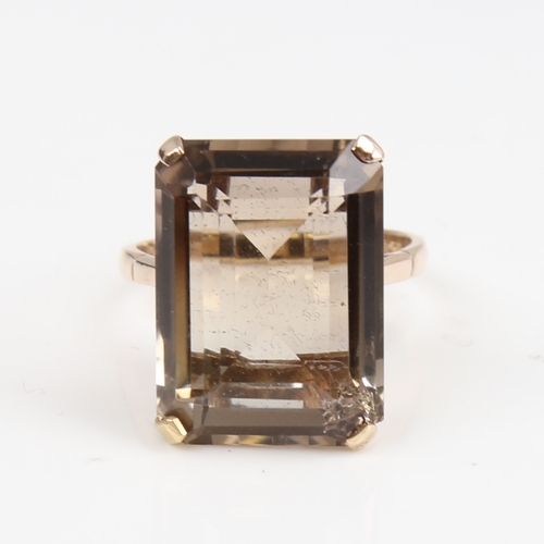 1389 - A large late 20th century 9ct gold smoky quartz ring, quartz length 20.2mm, size Q, 6.9g