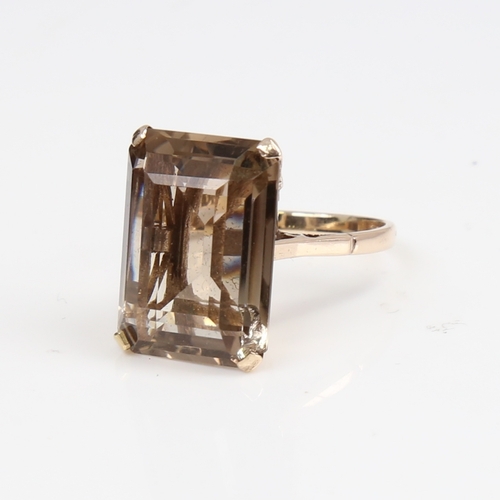 1389 - A large late 20th century 9ct gold smoky quartz ring, quartz length 20.2mm, size Q, 6.9g