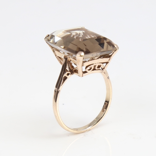 1389 - A large late 20th century 9ct gold smoky quartz ring, quartz length 20.2mm, size Q, 6.9g