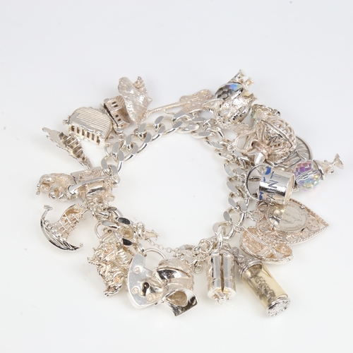 1391 - A late 20th century heavy sterling silver flat curb link charm bracelet, with heart padlock and fill... 