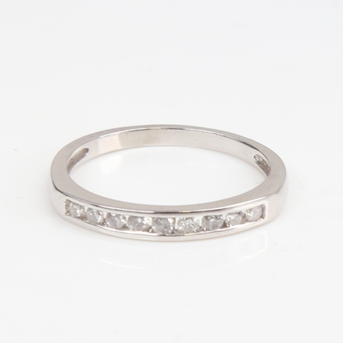 1393 - A modern unmarked white gold diamond half eternity ring, set with modern round brilliant-cut diamond... 