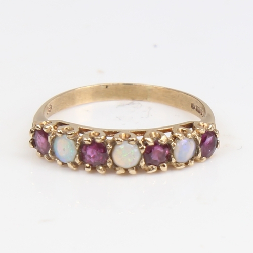 1397 - A late 20th century 9ct gold 7-stone opal and garnet half hoop ring, set with round cabochon opals a... 