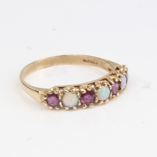 1397 - A late 20th century 9ct gold 7-stone opal and garnet half hoop ring, set with round cabochon opals a... 