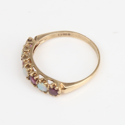 1397 - A late 20th century 9ct gold 7-stone opal and garnet half hoop ring, set with round cabochon opals a... 