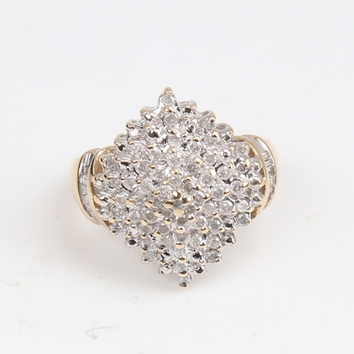 1403 - A modern 9ct gold diamond cluster cocktail ring, set with round brilliant and tapered baguette-cut d... 