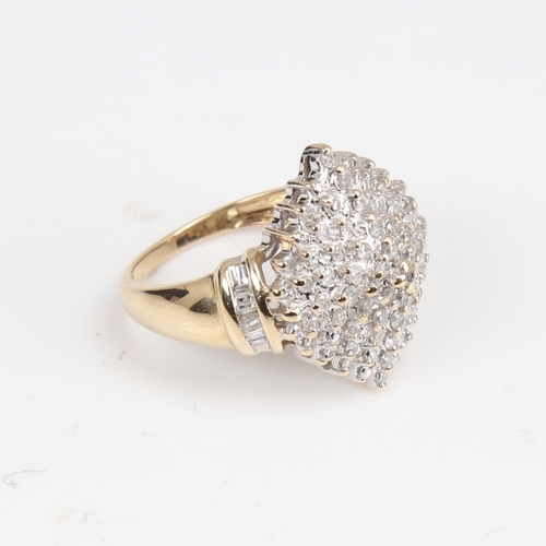 1403 - A modern 9ct gold diamond cluster cocktail ring, set with round brilliant and tapered baguette-cut d... 