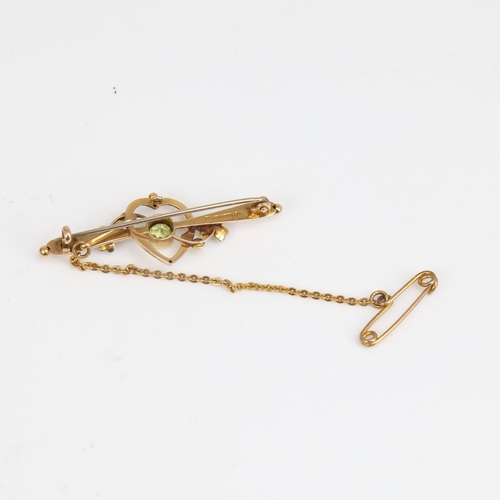 1406 - An early 20th century Art Nouveau 15ct gold peridot and split-pearl bar brooch, hallmarks Chester 19... 