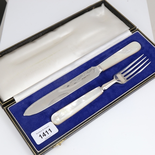 1411 - A cased Elizabeth II silver and mother-of-pearl handled cake carving set, by James Dixon & Sons, hal... 