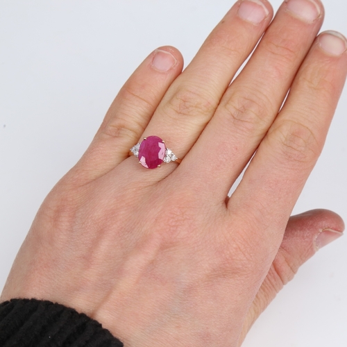 1418 - A modern 14ct rose gold ruby and diamond dress ring, set with oval mixed-cut ruby and round brillian... 