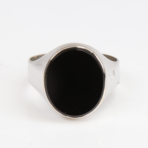 1420 - A large unmarked white gold onyx signet ring, setting height 17.5mm, size W, 5.9g