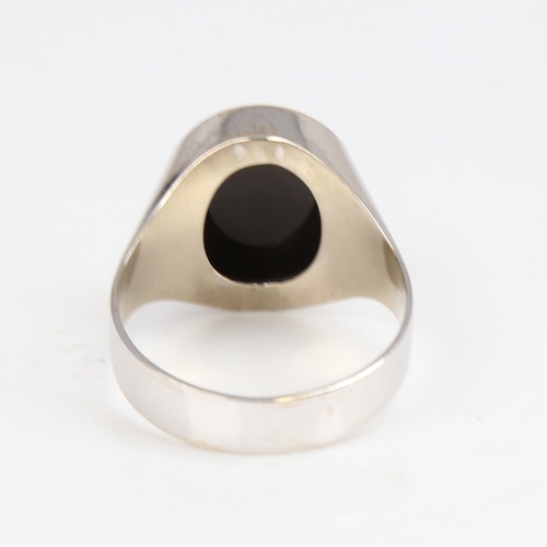 1420 - A large unmarked white gold onyx signet ring, setting height 17.5mm, size W, 5.9g