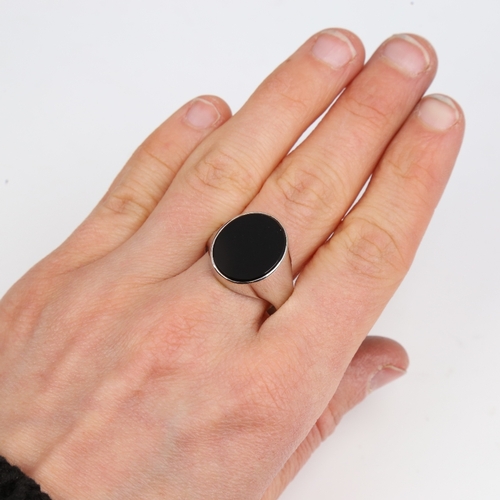 1420 - A large unmarked white gold onyx signet ring, setting height 17.5mm, size W, 5.9g