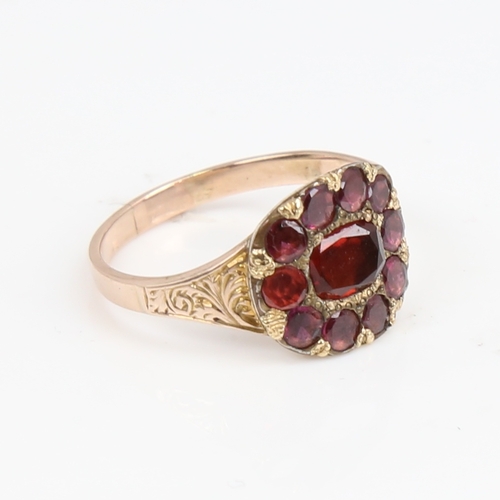 1425 - A Georgian unmarked gold flat-top garnet ring, foliate engraved shoulders with closed backs, setting... 