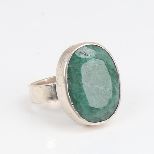 1427 - A modern sterling silver emerald ring, set with large oval mixed-cut emerald, setting height 24.3mm,... 