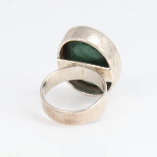 1427 - A modern sterling silver emerald ring, set with large oval mixed-cut emerald, setting height 24.3mm,... 