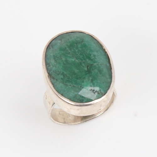 1427 - A modern sterling silver emerald ring, set with large oval mixed-cut emerald, setting height 24.3mm,... 