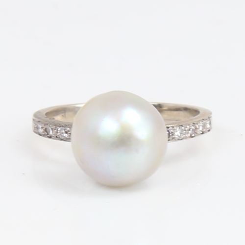 1428 - A 14ct white gold whole pearl and diamond ring, shoulders set with round brilliant-cut diamonds, pea... 