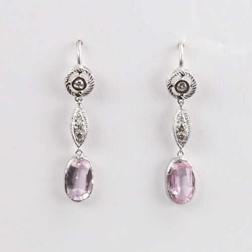 1429 - A pair of unmarked white metal pink topaz and diamond drop earrings, set with oval mixed-cut topaz a... 